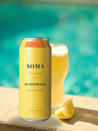 SOMA Lager can poolside next to a frosted glass of lager