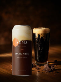 SOMA Stout can on a bar counter beside a pint of stout